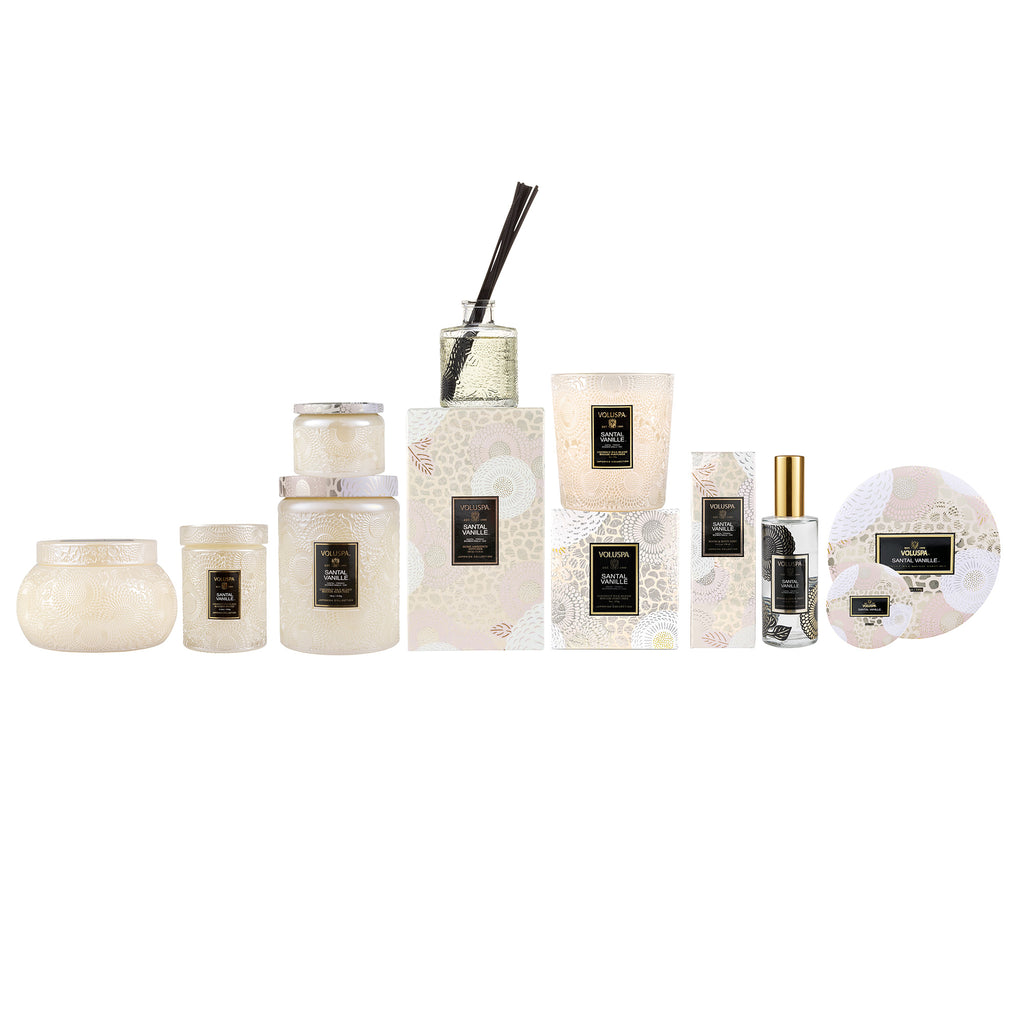Santal Vanille candle in a clear glass jar with white wax.