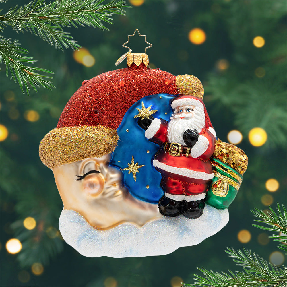 Crescent Wishes Santa ornament featuring Santa standing on a moon with a glittery red hat.