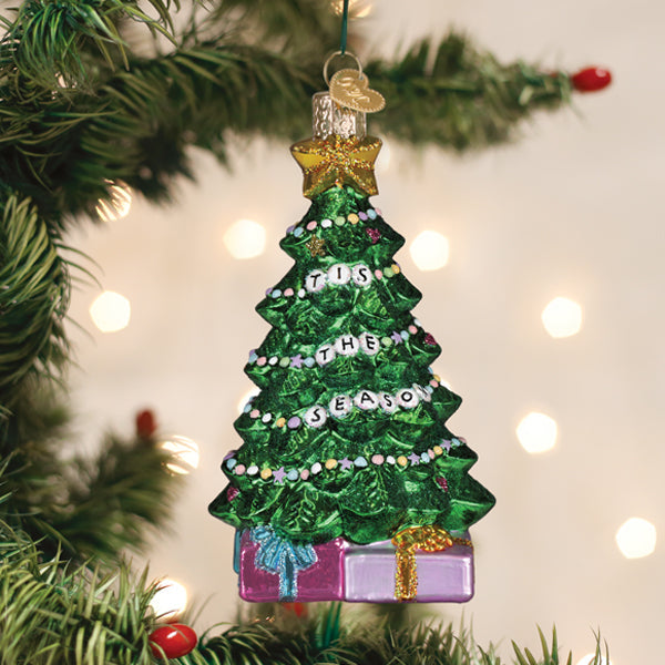 Small Friendship Tree ornament made of wood with strung bracelets tied to its branches.