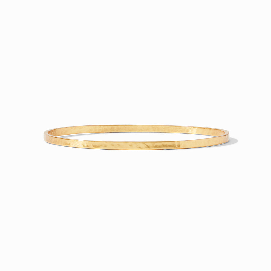 Slender hammered crescent bangle in silver with a light metallic luster.
