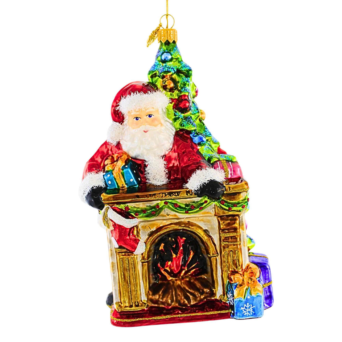 Glass Christmas ornament featuring Santa Claus leaning over a fireplace next to a decorated tree.