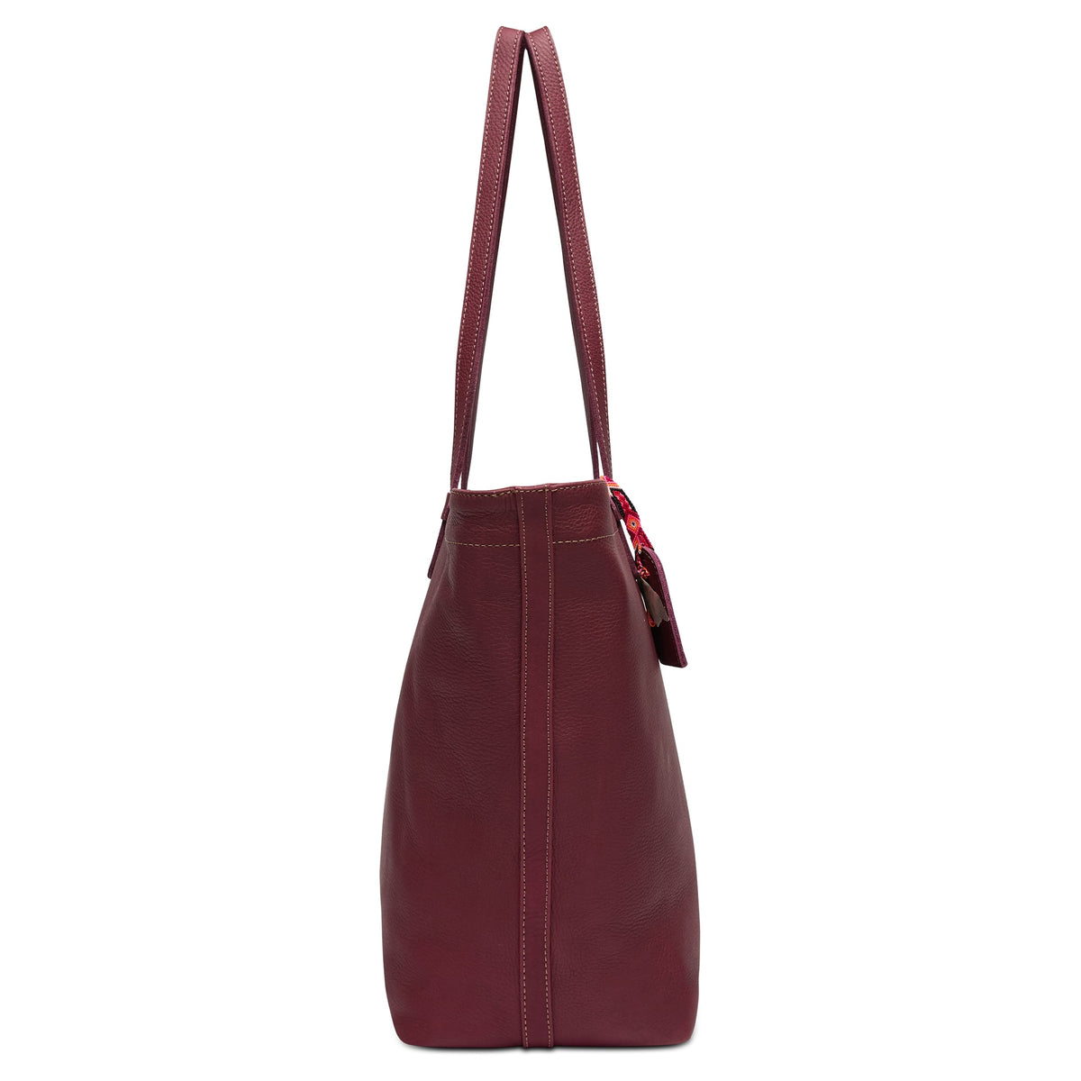 Plum Daily Tote in pebble leather with zipper closure, interior slide pocket, hook-clip lanyard, and attached hand-woven friendship bracelet bag tag.
