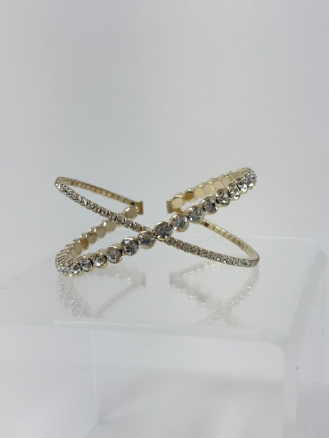 Crossover gold adjustable bracelet with two rows of sparkling clear rhinestones.