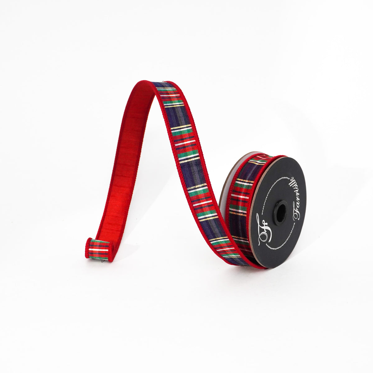 Spool of Christmas plaid ribbon with red velvet backing and a navy, green, and gold striped pattern.