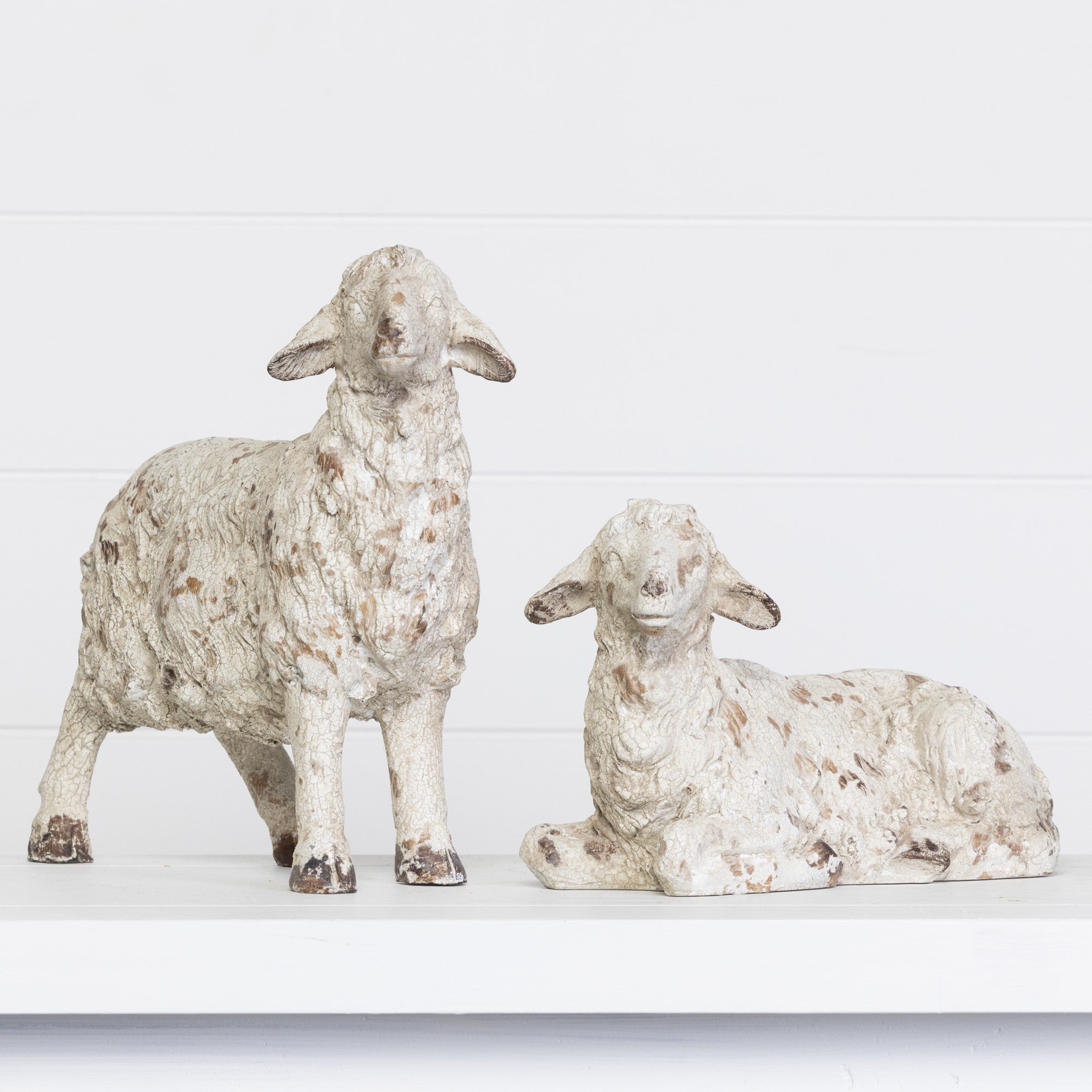 Resin decorative lamb figurine in natural tone with smooth curves.