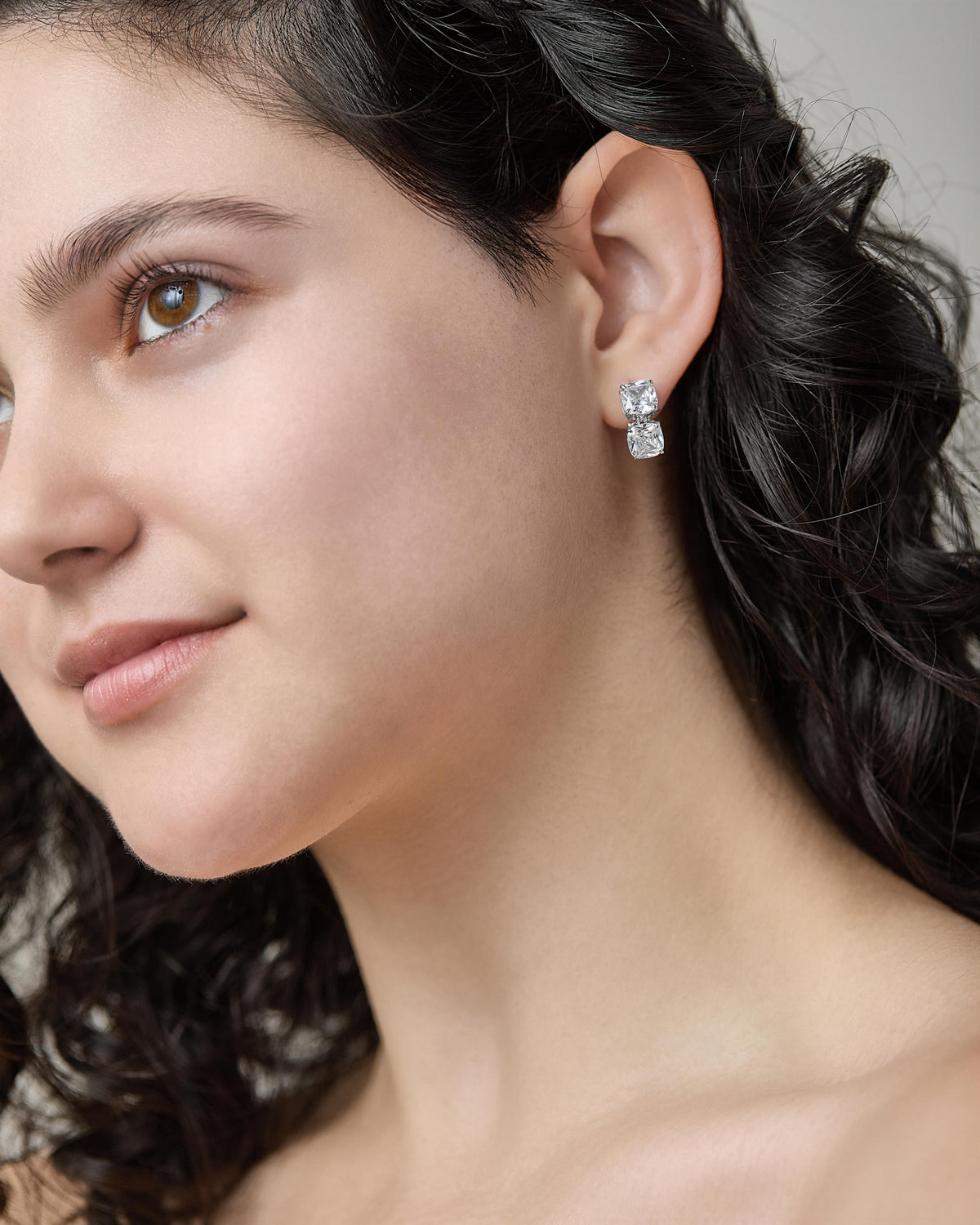 Clair double drop earrings featuring hand-set cushion-cut clear cubic zirconia on a pierced post.