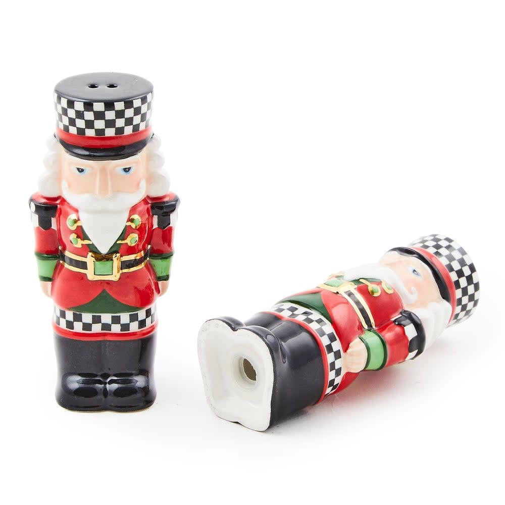 Hand-painted red ceramic salt and pepper shakers with green accents, checkered patterns, gold lustre trim, and nutcracker silhouettes.