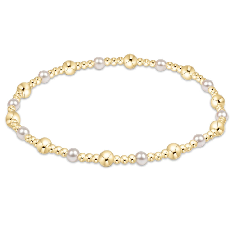 Classic gold sincerity pattern bracelet featuring 4mm crystal pearls mixed with small 14kt gold-filled beads on elastic cord.