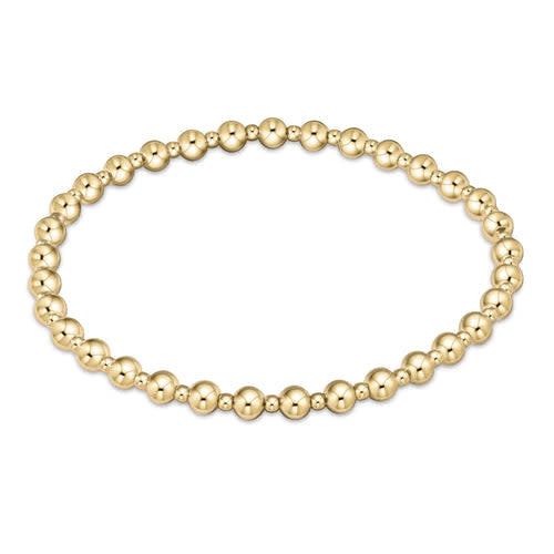 Gold beaded bracelet with alternating bead sizes in a classic grateful pattern on elastic cord.