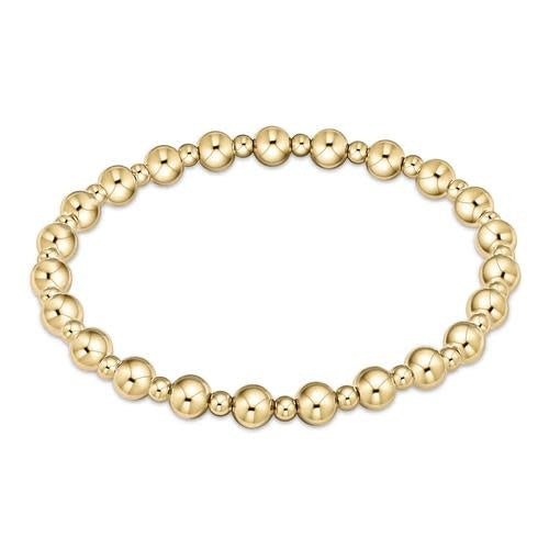 Gold beaded bracelet with alternating 5mm and 3mm beads in a classic grateful pattern on elastic cord.