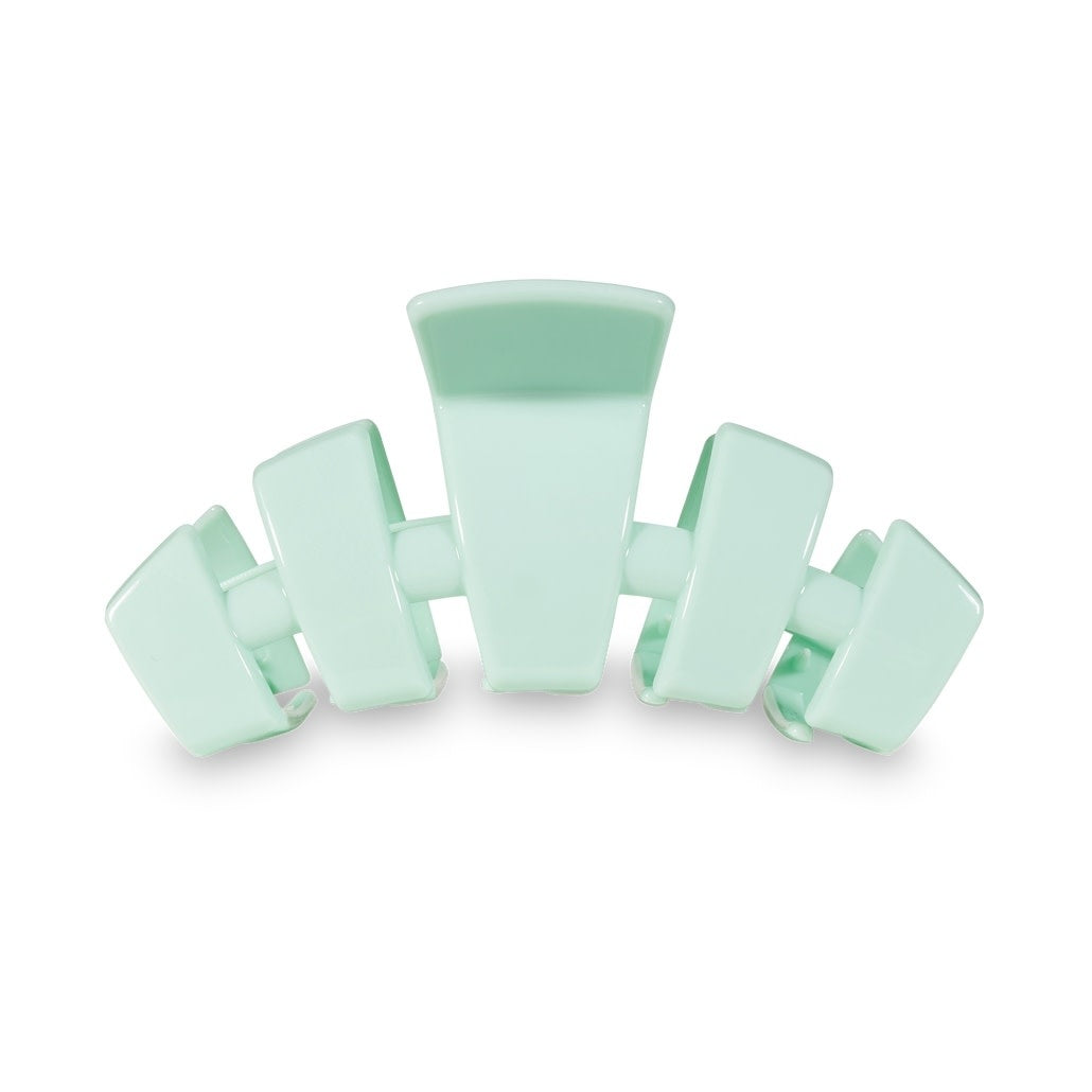 Large mint green hair clip with bendable teeth designed for thick hair.