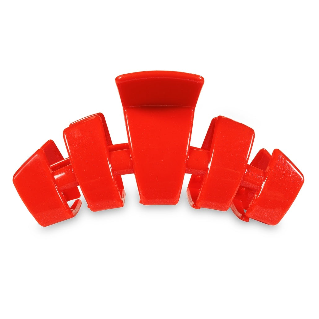 Large red hair clip with bendable teeth designed for thick hair.
