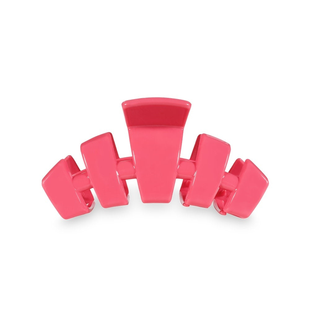 Small classic hair clip with bendable teeth in a neutral tone.