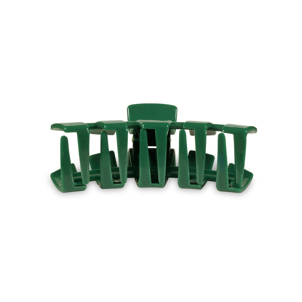 Small classic hair clip with bendable teeth in a solid color.