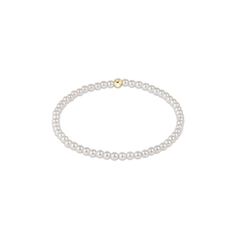 Classic Pearl bracelet featuring small round white beads strung on a delicate cord.