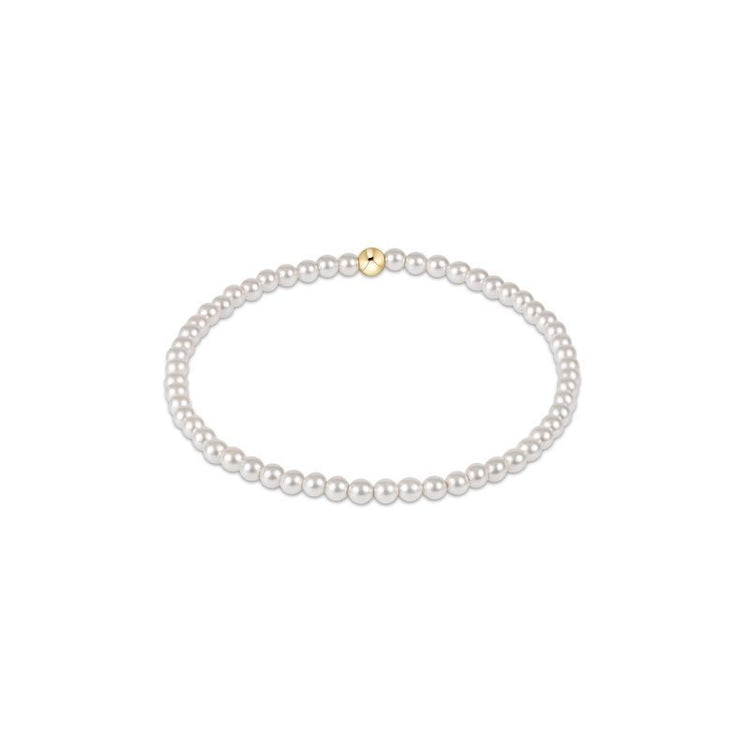 Classic Pearl bracelet featuring small round white beads strung on a delicate cord.