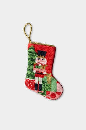 Classic Nutcracker figurine with red hat, black beard, gold accents on blue uniform.