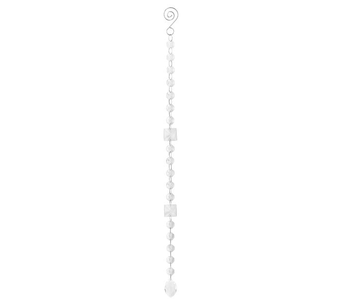 Clear glass bead strand with round and square pieces featuring an oval pendant and silver loop top.
