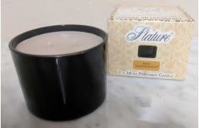 Clear glass candle jar with white soy wax, black wick, and 'Stature Collection Clear' label.