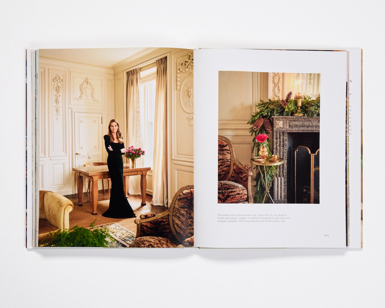 Open pages of Aerin Lauder: Living with Flowers book featuring interior holiday decor and portraits.