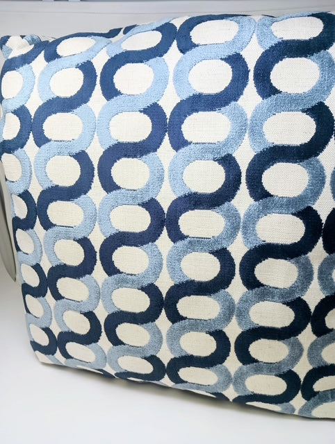 A 24x24 hand-crafted pillow with a repeating pattern of interlocking blue and light blue ovals on a cream background.