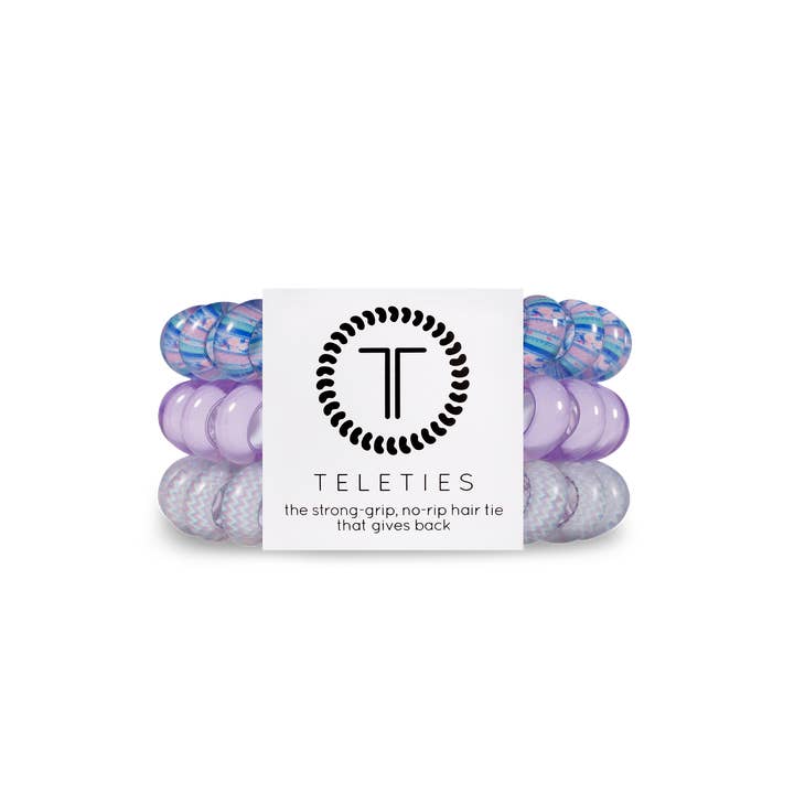 Three large black spiral hair coils with a bracelet-style grip.