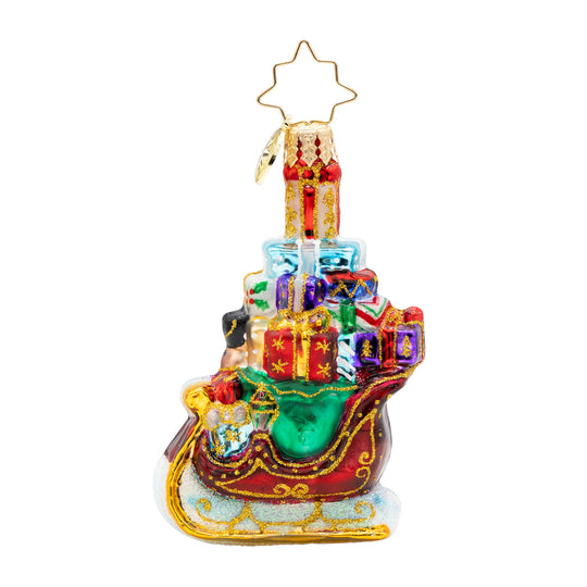 Sleighful of Surprises Gem glass ornament featuring a red sleigh filled with colorful gifts.