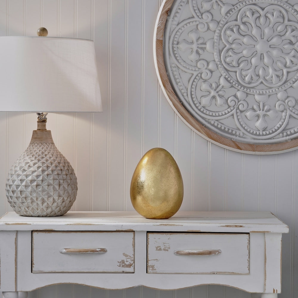 Resin golden egg with smooth oval silhouette in metallic gold finish