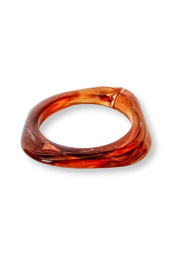 WS Lumi Bangle featuring a bold square design in a marbled amber and brown resin finish.