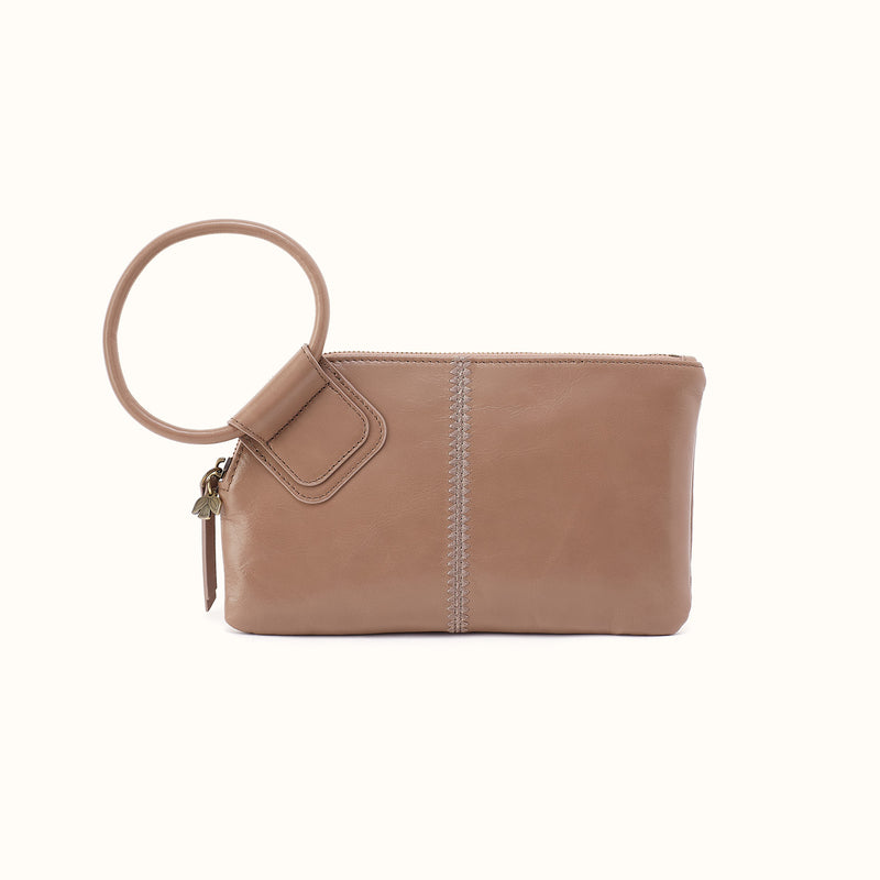Sable wristlet clutch in woodsmoke leather with a circular handle and decorative stitching.