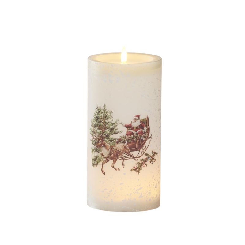 White LED pillar candle in a glass vessel featuring Santa in a reindeer-drawn sleigh winter scene.