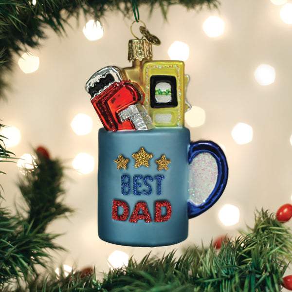 Glass Christmas ornament of a blue mug with tools inside and glittery Best Dad text.