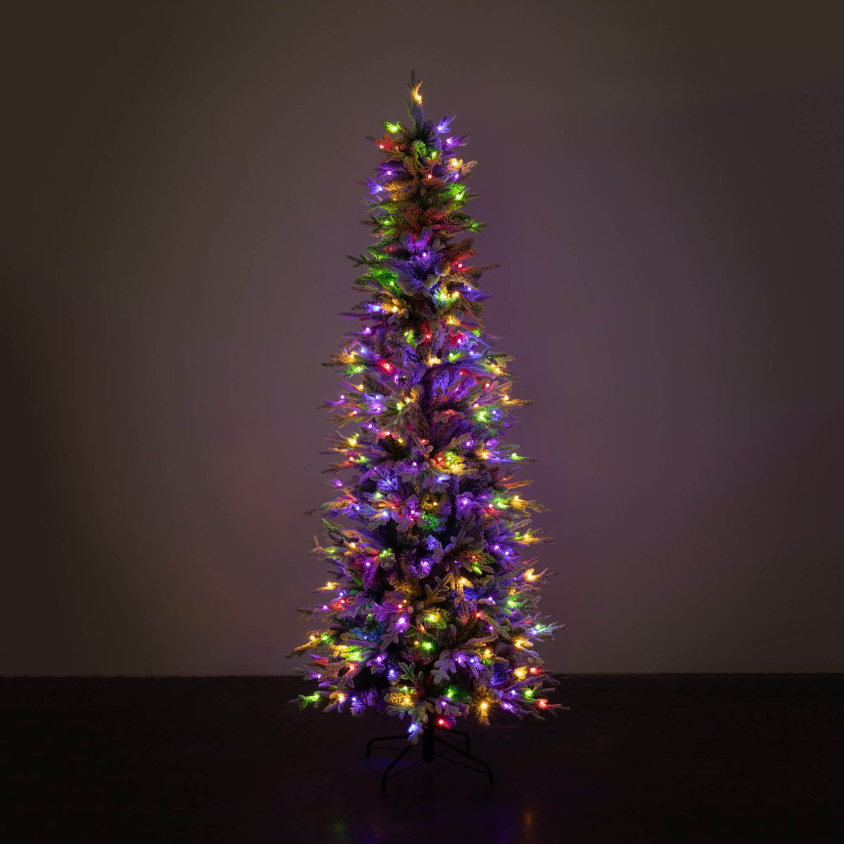 7.5' LED Pencil Flocked Tree with multi-colored lights against a dark background.