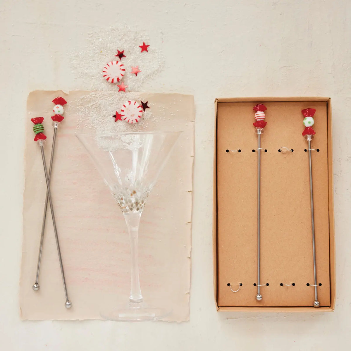 Set of stainless steel cocktail stirrers topped with colorful hand-blown glass candy decorations.