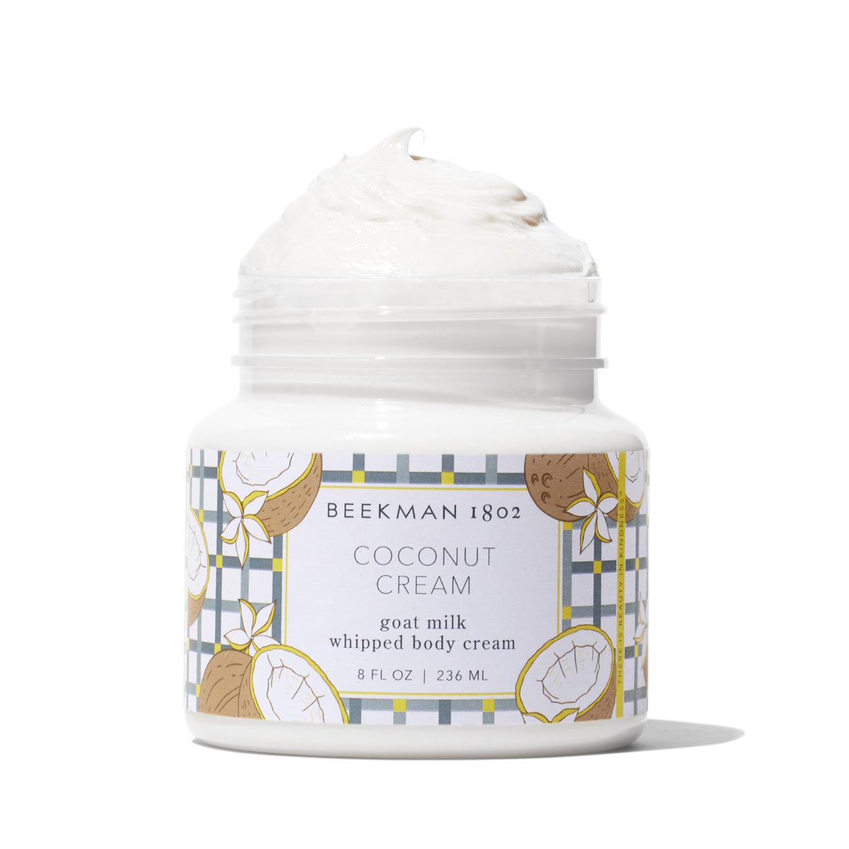 White whipped body cream in a clear jar with coconut imagery on the label.