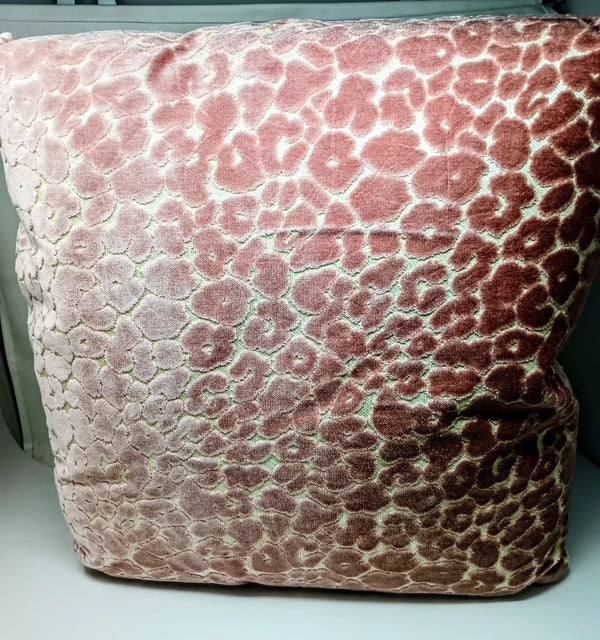 A plush velvet pillow with a pink leopard print pattern, measuring 24 x 24 inches.