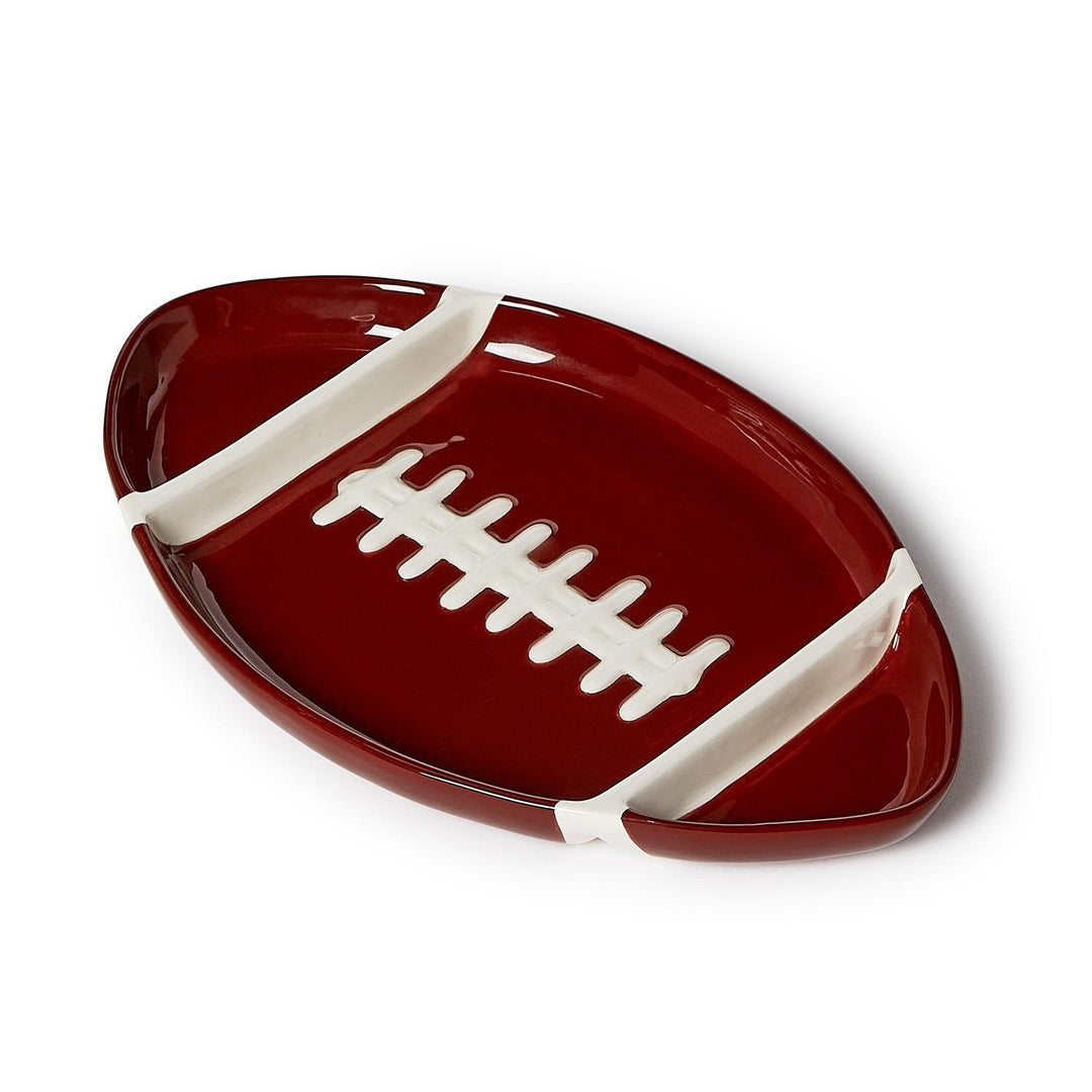 Football-shaped sectional serving platter in glossy maroon dolomite with white laces and stripes.