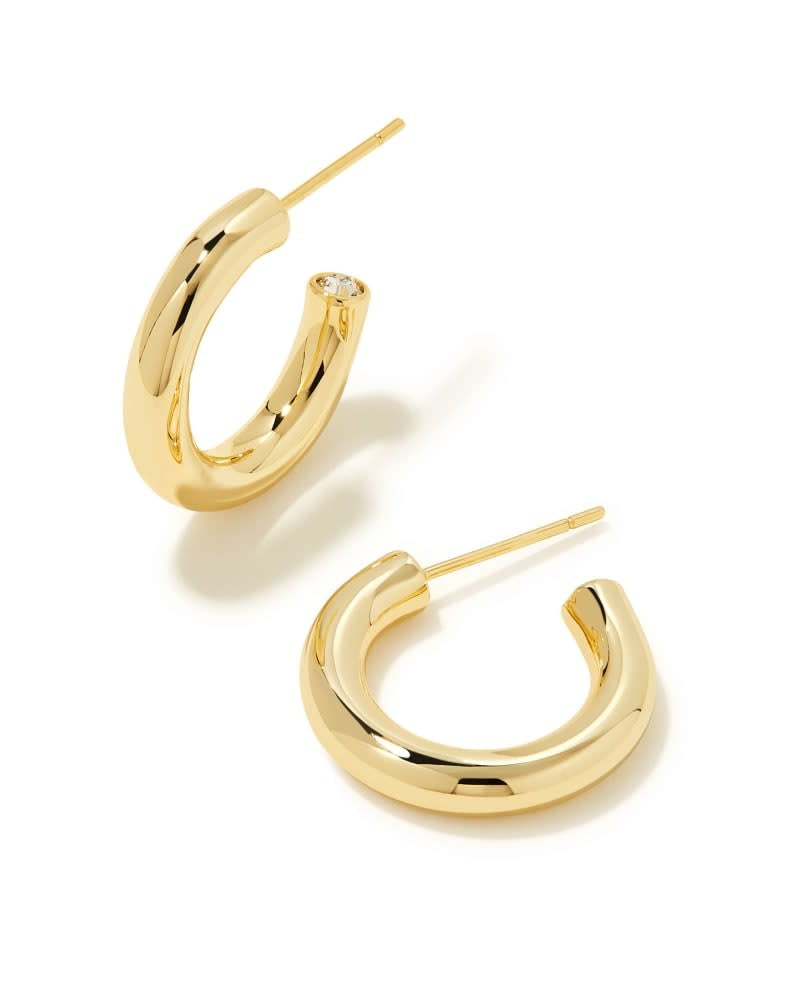 Gold Colette Huggie Earrings with a minimalist hoop silhouette on an ear post.