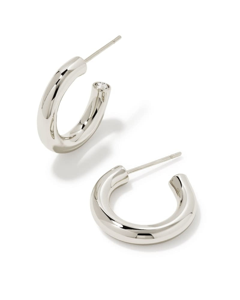 Silver minimalist huggie hoop earrings with a simple ear post closure.