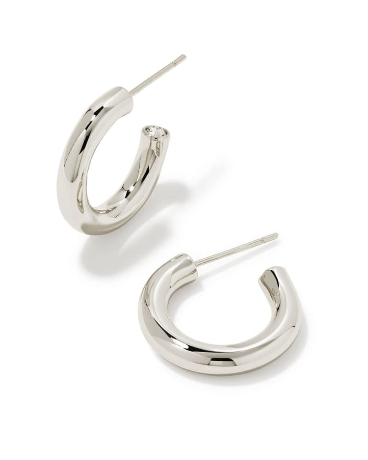 Silver minimalist huggie hoop earrings with a simple ear post closure.