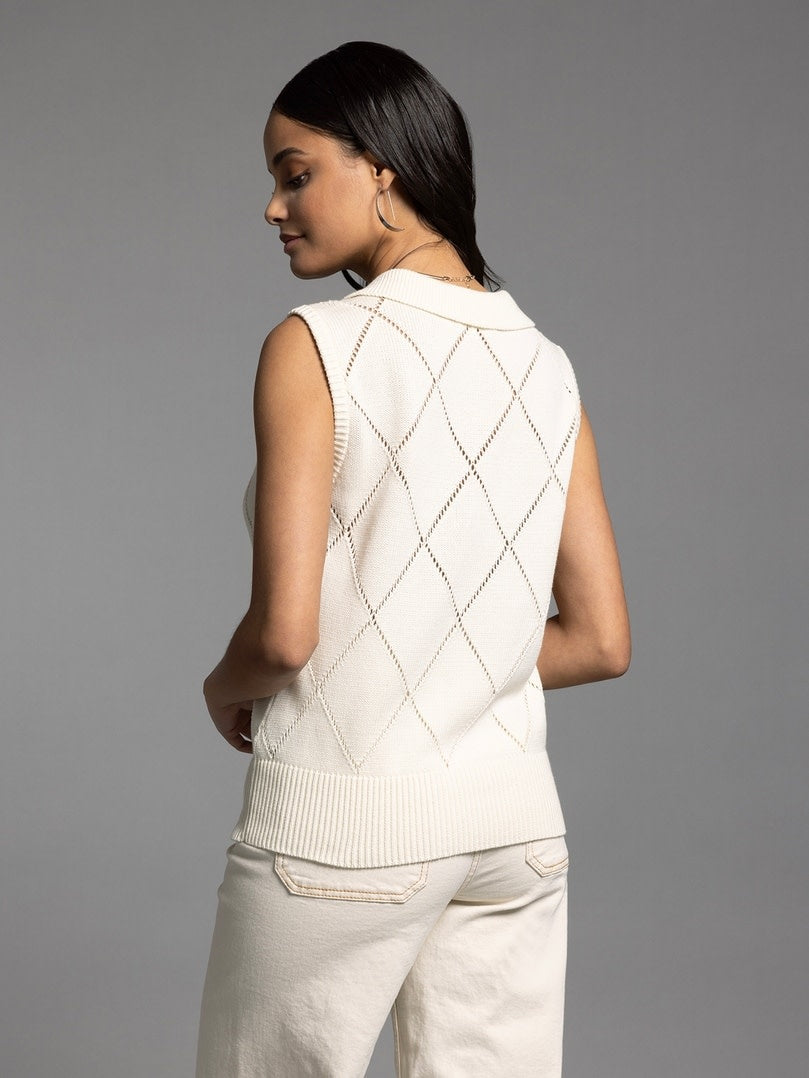 Back view of a creme knit sleeveless top with a collared neckline.