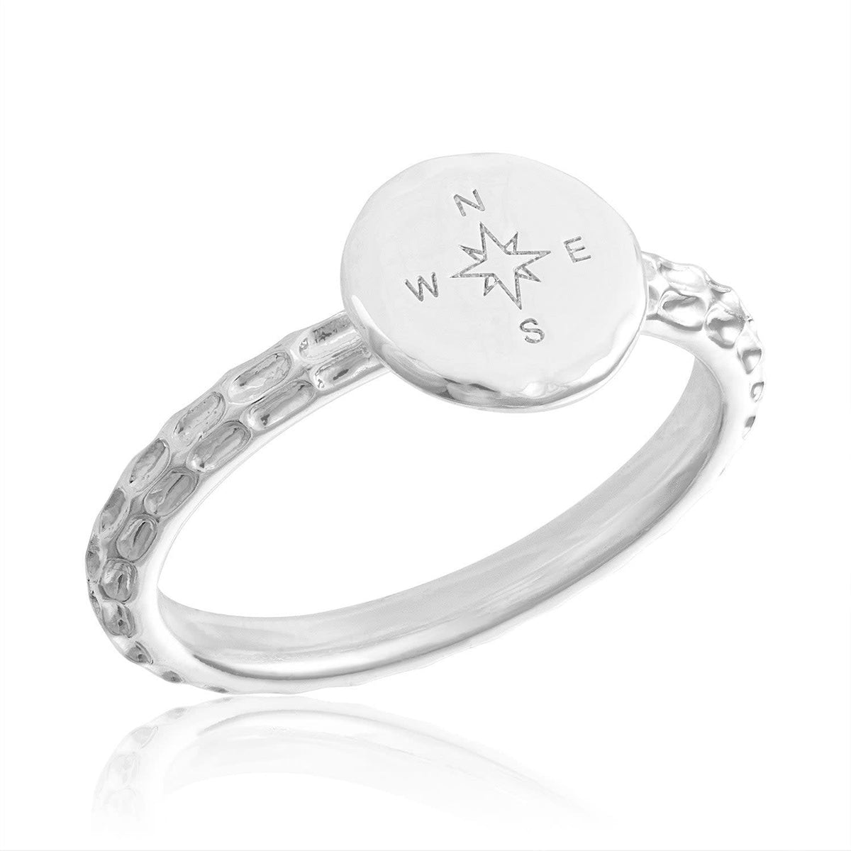 Stackable gold-colored compass ring with a minimalist circular band featuring engraved directional points.