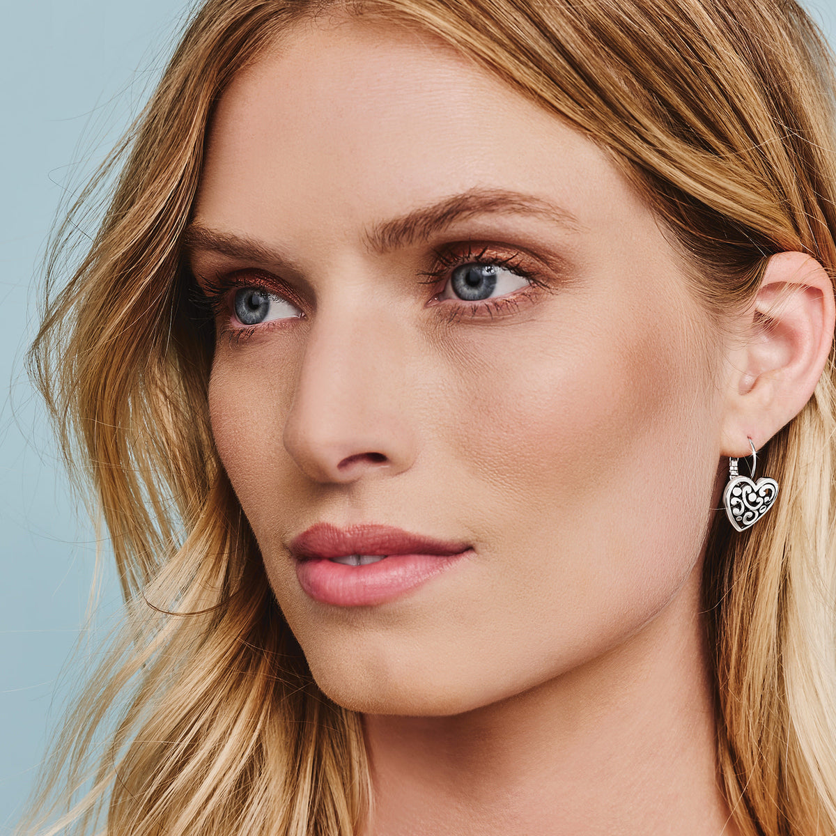 Silver plated French wire leverback earrings featuring a heart-shaped drop with a width of 5/8 inch and a total length of 3/4 inch.