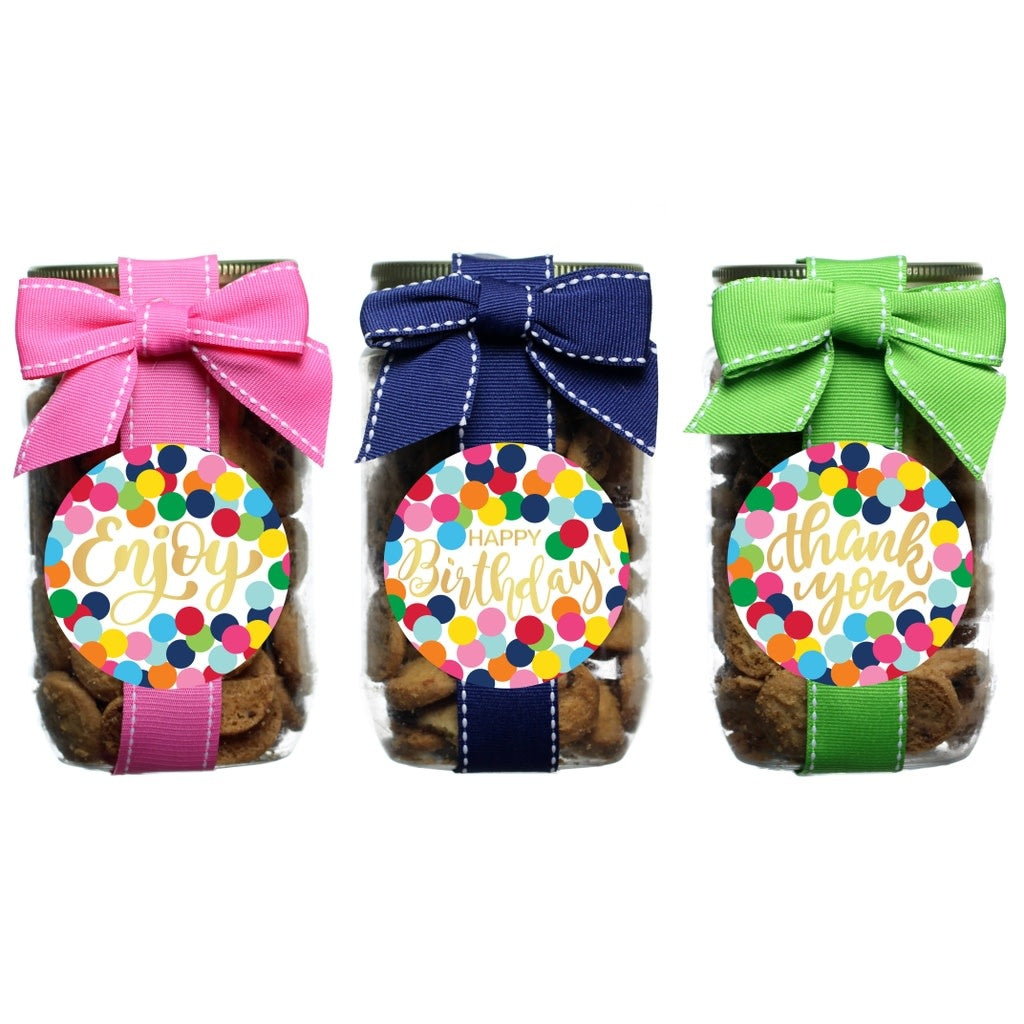 Glass pint jar filled with confetti dot cookies featuring colorful speckled pattern on white background