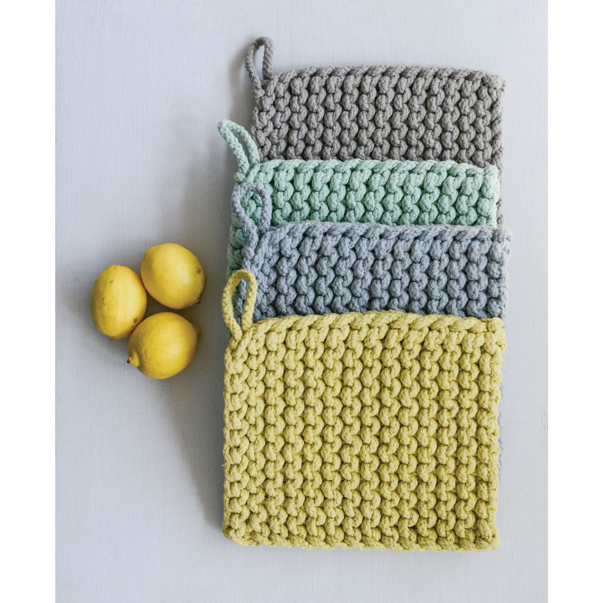 8-inch square cotton crocheted pot holder in natural beige with openwork lace pattern
