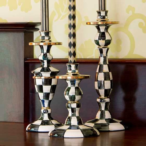 Small Courtly Check enamel candlestick with hand-painted blue pattern on steel base and bronzed stainless rim.