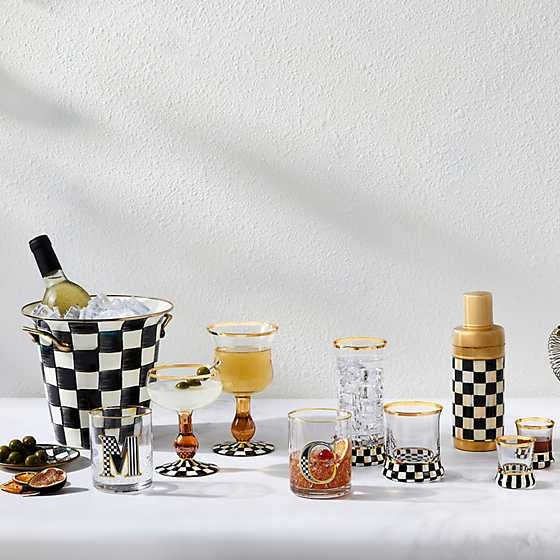 Hand-painted Courtly Check glass tumbler with gold lustre trim on a patterned base.