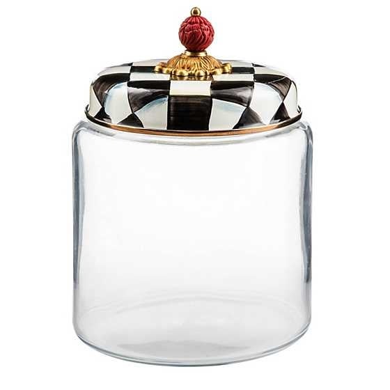 Large glass kitchen canister with black-and-white checkered enamel lid featuring brass accents