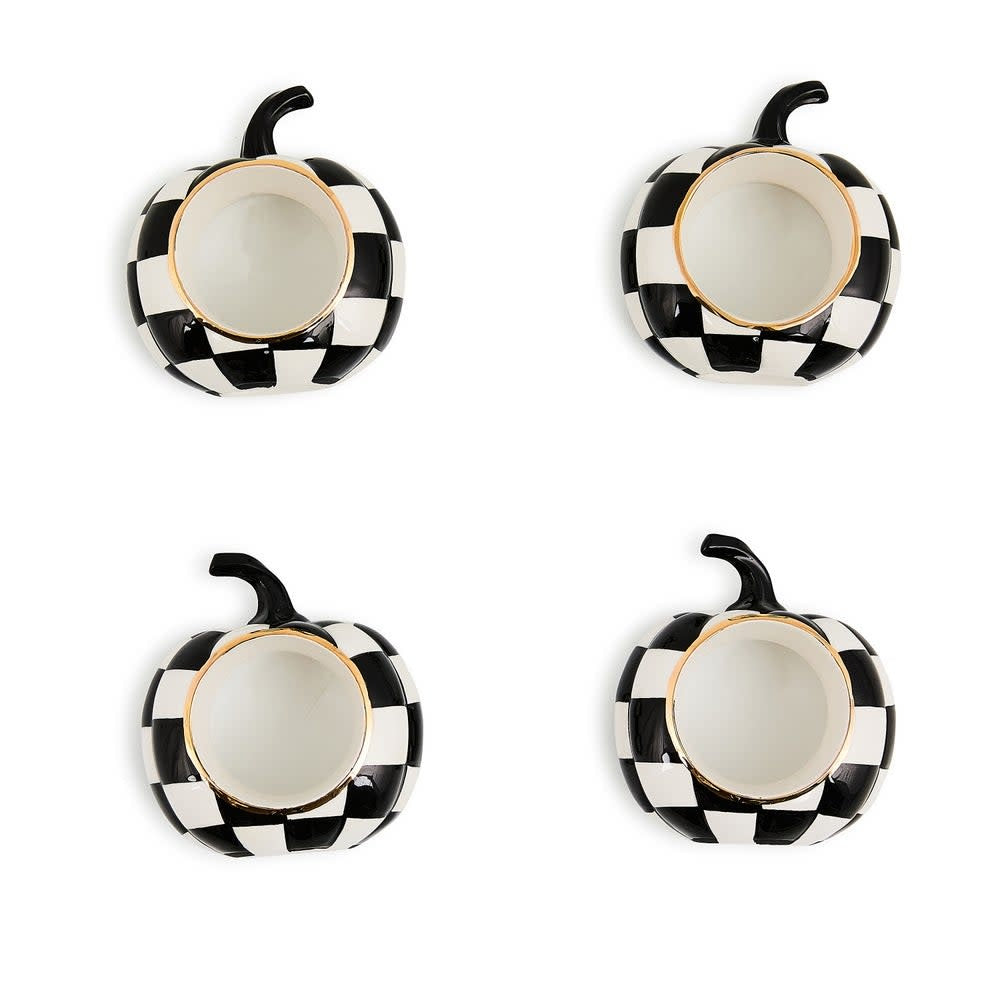 Set of four black ceramic napkin rings with a white pumpkin pattern.