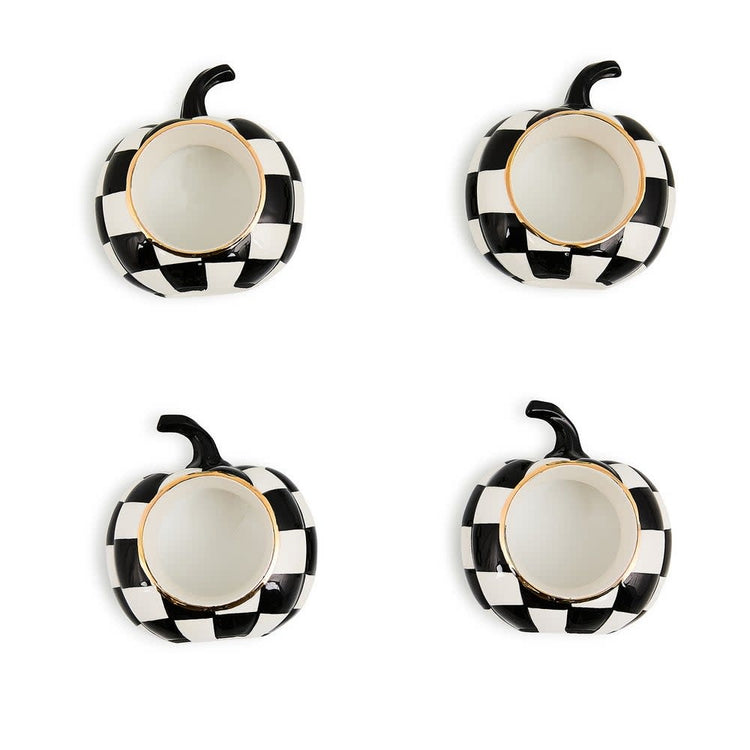 Set of four black ceramic napkin rings with a white pumpkin pattern.